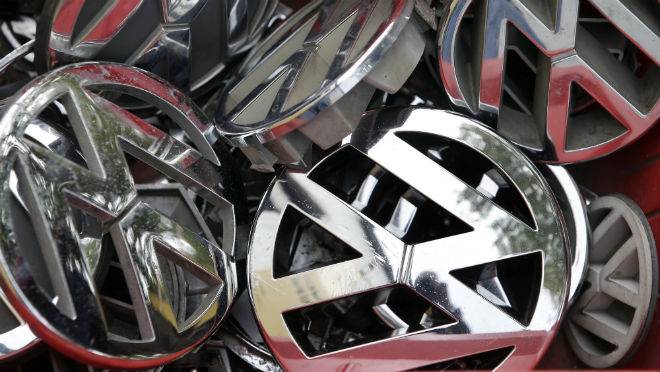 Volkswagen ornaments sit in a box in a scrapyard in Berlin