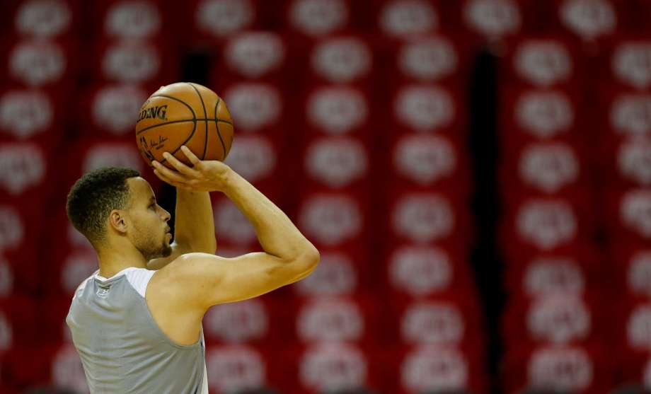 Golden State Warriors point guard Stephen Curry shoots baskets during team practice at Toyota Center Wednesday