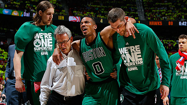 Avery Bradley is assisted off the court after an injury against the Atlanta Hawks in Game One of the Eastern Conference Quarterfinals during the 2016 NBA Playoffs at Philips Arena