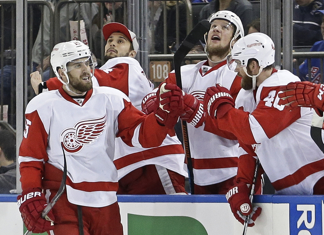 Detroit Red Wings Riley Sheahan celebrates with teammates after scoring a goal during the second period of an NHL hockey game against the New York Rang