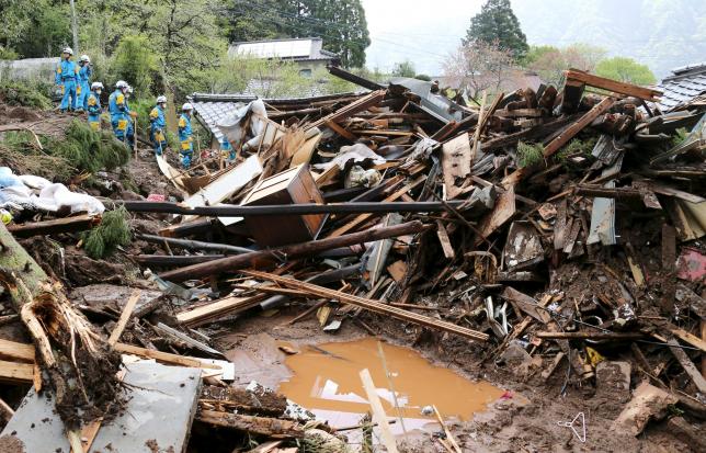 Rescue workers conduct search and rescue operations at a collapsed house at a landslide site caused by earthquakes in Minamiaso town Kumamoto prefecture southern Japan in this