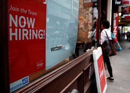 A'Now Hiring sign is posted on a Verizon store in Manhattan in New York