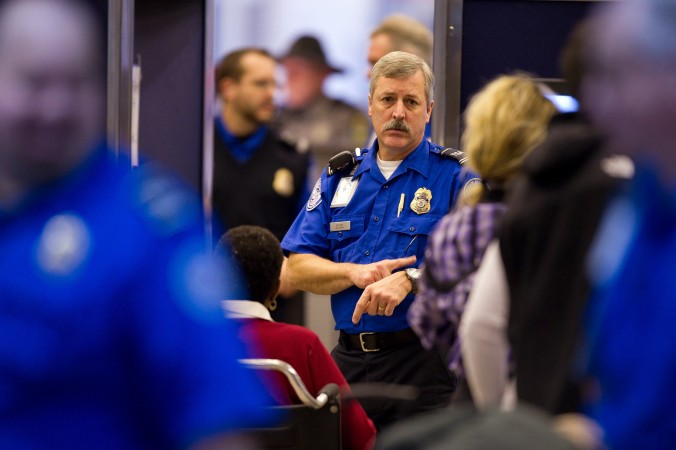 A TSA agent instructs travelers through the security lines at the Pittsburgh International Airport on Nov. 24 2010