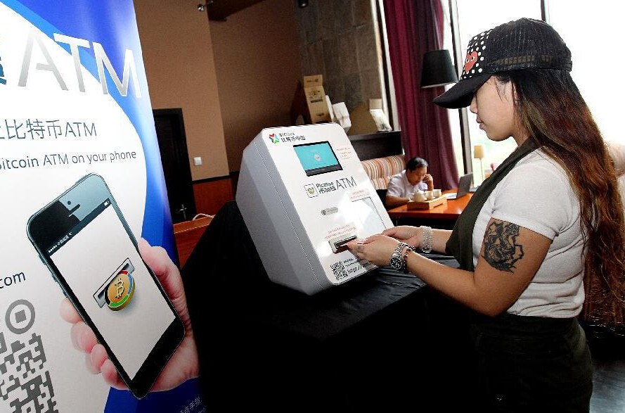 A citizen buys bitcoins on a bitcoin ATM in Shanghai