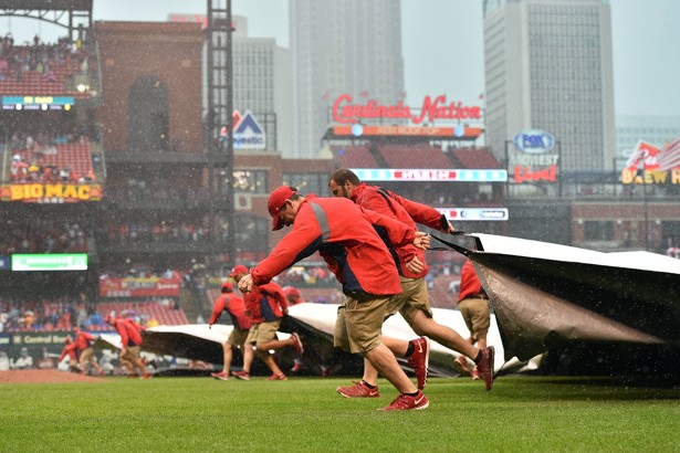 A grounds crew for the St. Louis Cardinals works to cover the field during a rain delay at Busch Stadium.                       Jasen Vinlove  USA TODAY Sports