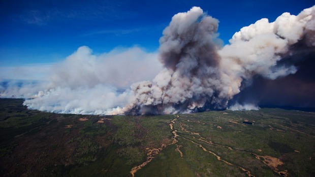 A huge plume of smoke rises from wildfires burning near Fort McMurray Alberta Canada