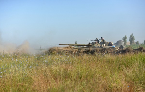 A member from the Iraqi security forces stands on a tank on the outskirts of Falluja Iraq