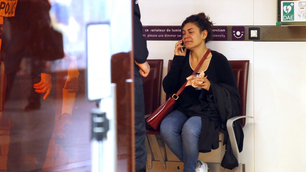 A relative of a passenger on Egypt Air flight 804 makes an emotional phone call at Charles de Gaulle Airport outside of Paris on Thursday