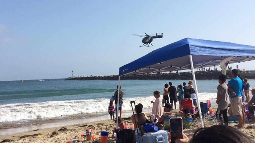 A stretch of Corona del Mar State Beach was evacuated after a woman was possibly bitten by a shark