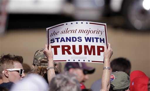 A supporter holds up a sign as Republican presidential candidate Donald Trump speaks at a rally Saturday in Lynden Wash