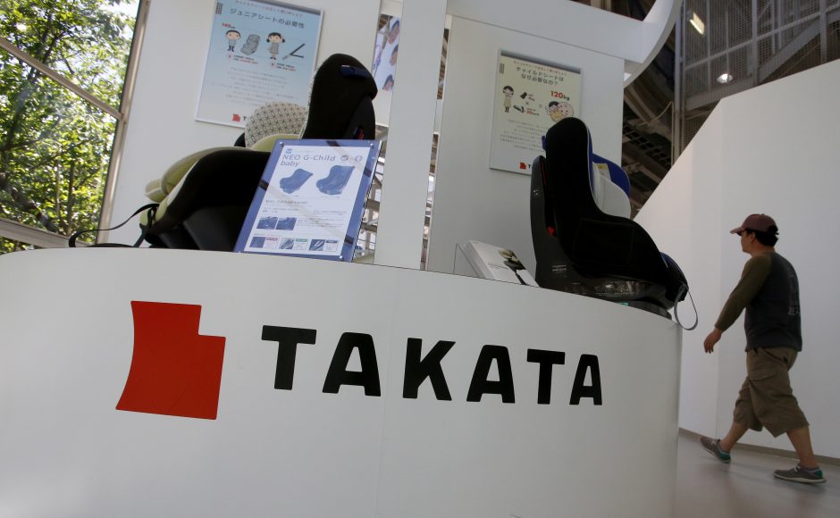 A visitor walks past child seats manufactured by Takata Corp. displayed at an automaker's showroom in Tokyo. Pic AP