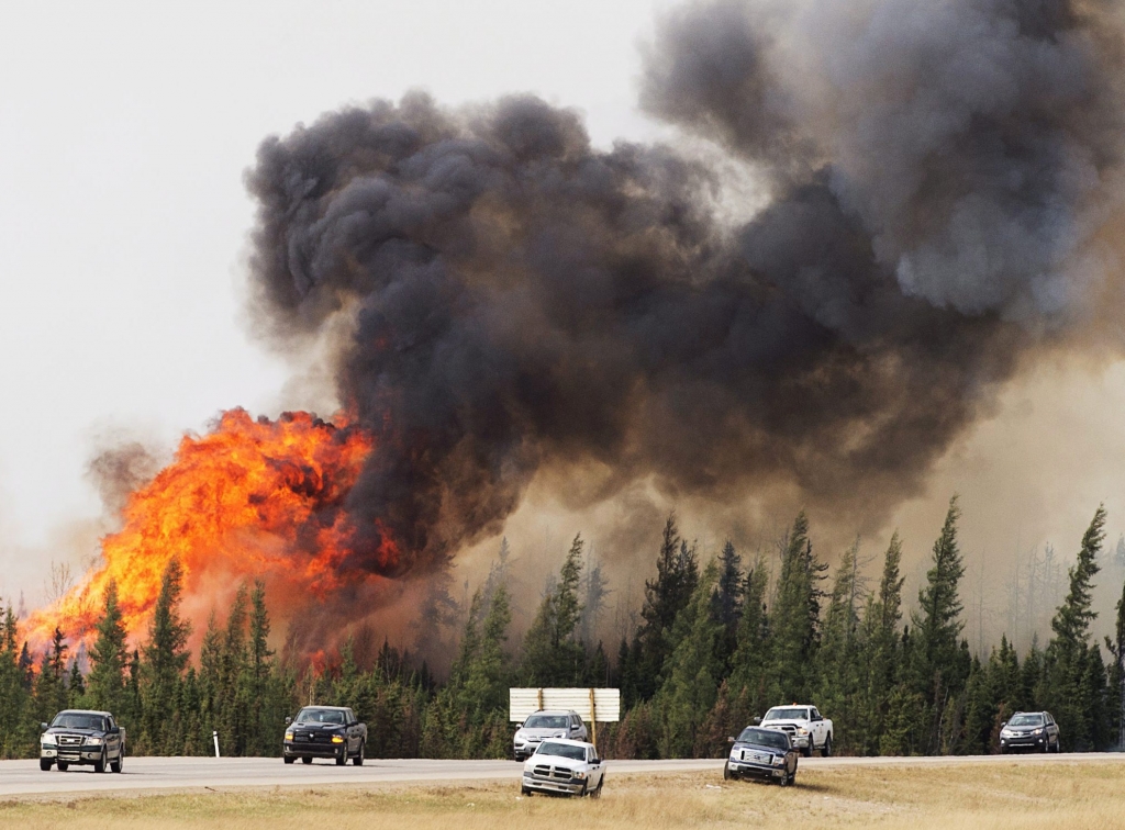 A wildfire burns south of Fort McMurray Alberta near Highway 63 on Saturday