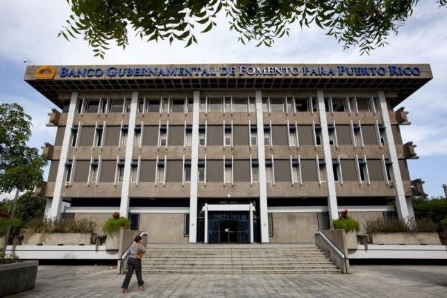 A woman walks at the headquarters of the Government Development Bank of Puerto Rico in San Juan