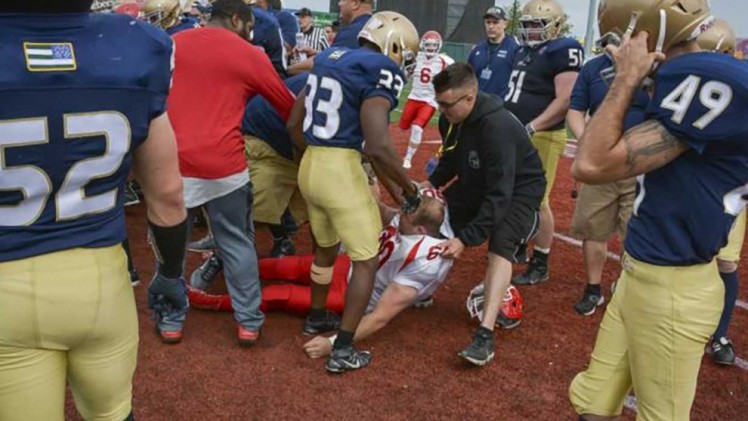 An injured firefighter is helped during the fight