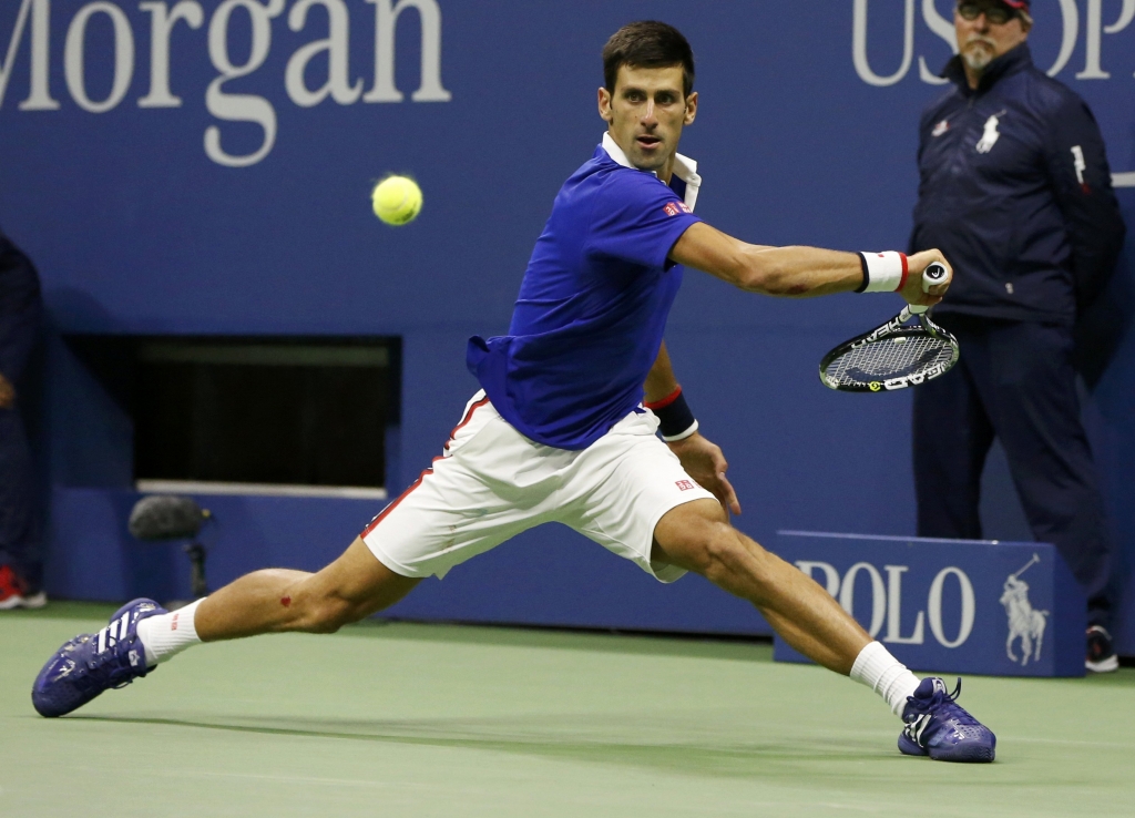 Novak Djokovic of Serbia returns a backhand to Roger Federer of Switzerland during their men's singles final match at the US Open Championships tennis tournament in New York