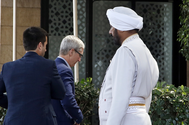 Apple chief Tim Cook center arrives at the Taj Mahal hotel in Mumbai India Wednesday