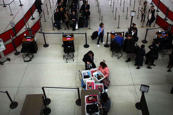 Are checked baggage fees responsible for long lines at security checkpoints