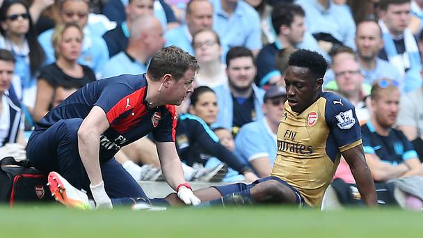 Arsenal's Danny Welbeck looks dejected after suffering an apparent knee injury