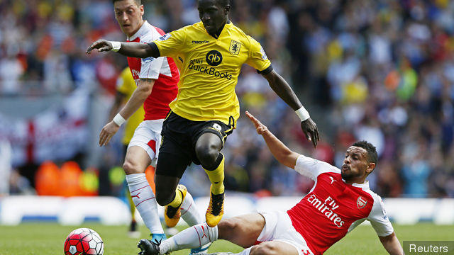 Arsenal's Francis Coquelin and Mesut Ozil in action with Aston Villa's Idrissa Gueye