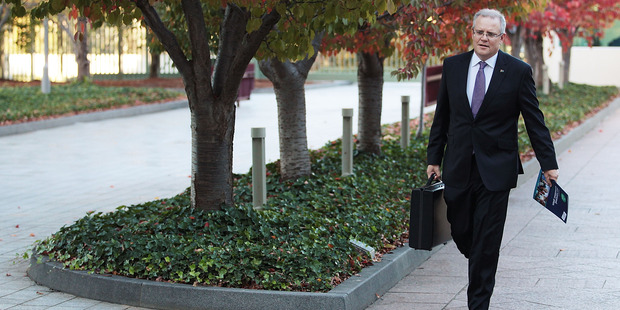 Australian Treasurer Scott Morrison arrives at Parliament House last night to deliver the budget that includes a'Google Tax