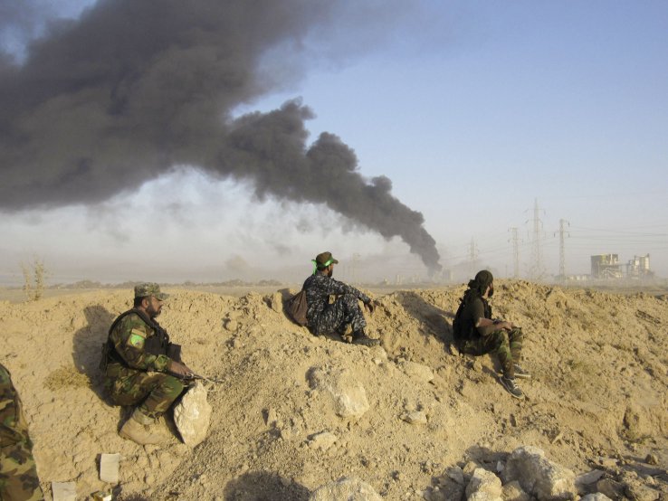 Badr Organisation fighters deployed on the outskirts of Al Fallujah watch an airstrike on 23 May