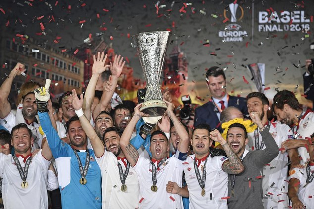 Sevilla players celebrate with the trophy after winning the Europa League final soccer match between Liverpool and Sevilla in Basel Switzerland Wednesday