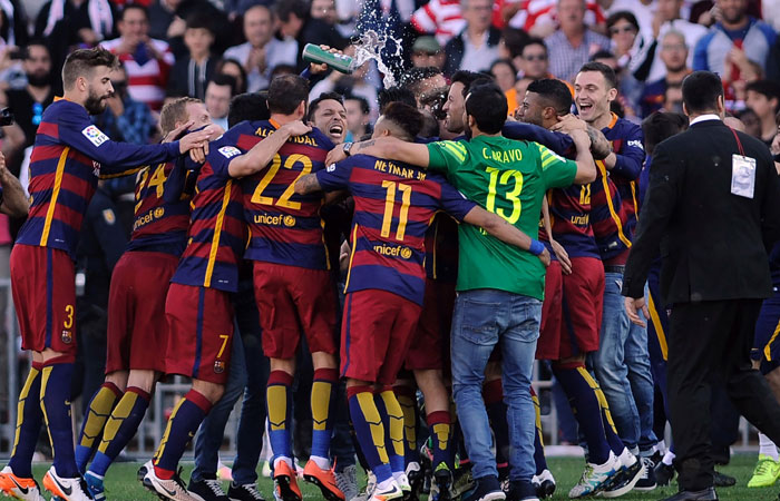 Barcelona's players celebrate their 24th La Liga title at Nuevo Los Carmenes Stadium in Granada Saturday. — AFP