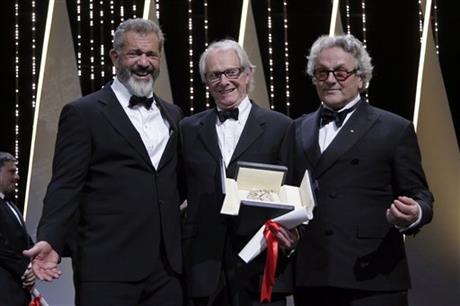 Director Ken Loach centre actor Mel Gibson left and President of the Jury George Miller react after Roach is awarded the Palme d'or for the film I Daniel Blake during the awards ceremony at the 69th international film festival Cannes southern