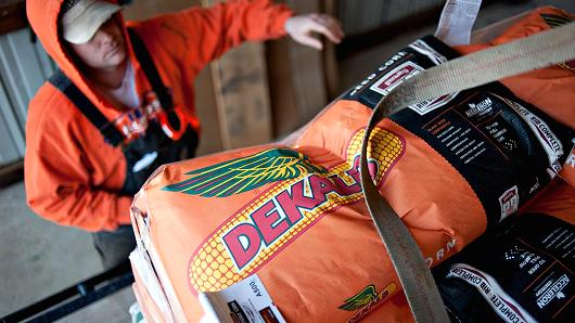 A farmer unstraps a delivery of Monsanto De Kalb brand seed corn on a farm in Princeton Ill