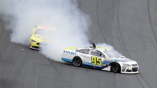 Michael Mc Dowell spins in front of Brian Scott as they exit Turn 4 during the NASCAR Sprint Cup Series Showdown auto race at the Charlotte Motor Speedway in Concord N.C. Friday