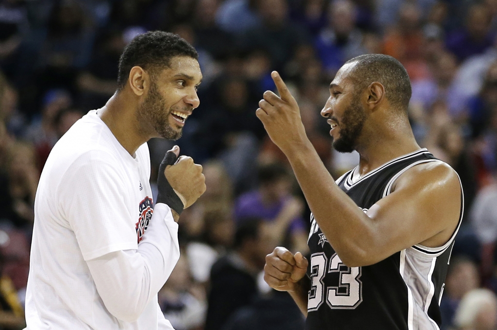 San Antonio Spurs center Tim Duncan left greets teammate Boris Diaw as he walks off the floor during timeout in the closing moments of the Spurs 106-88 win over the Sacramento Kings in Sacramento Calif. Monday Nov. 9 2015