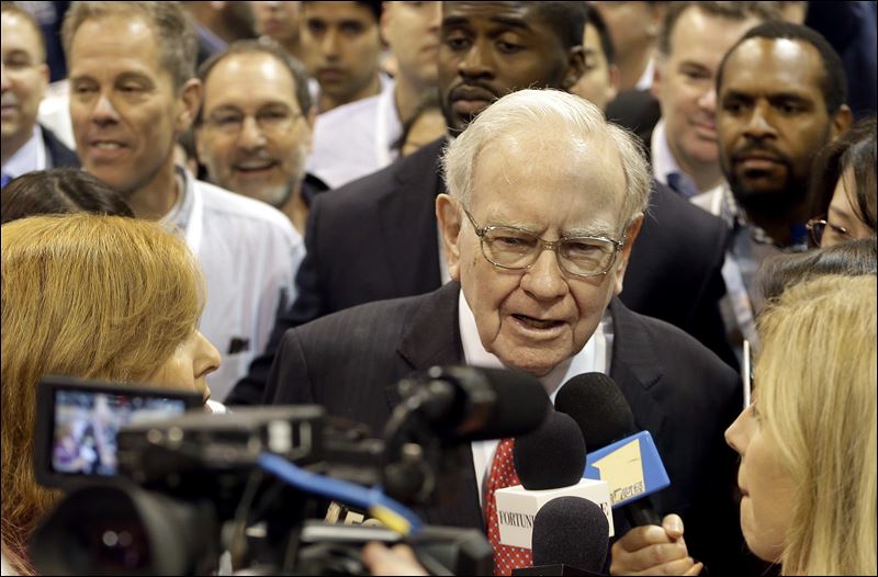 Berkshire Hathaway Chairman and CEO Warren Buffett tours the exhibit floor before presiding over the annual shareholders meeting Saturday in Omaha Neb