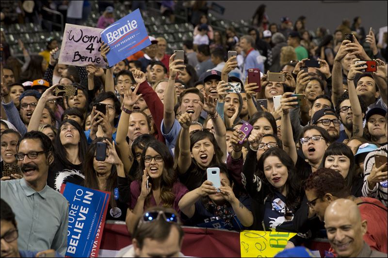 Supporters cheer for Democratic presidential candidate Bernie Sanders during a rally on Tuesday in Carson Calif