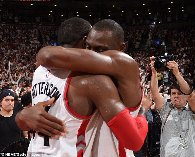 Bismack Biyombo hugs Patrick Patterson after Toronto Raptors beat Cleveland Cavaliers