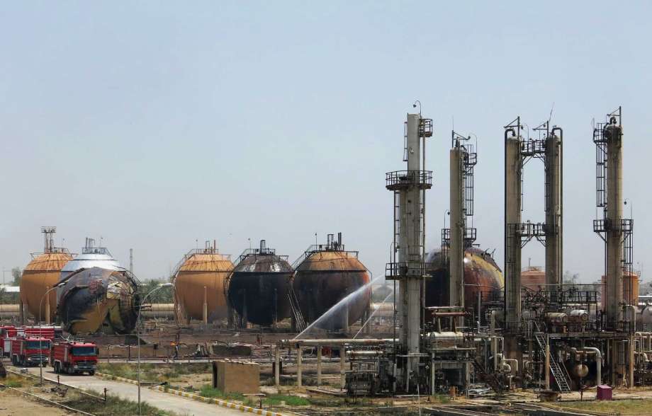 Iraqi firefighters try to extinguish a fire at a natural gas plant in Taji 12 miles north of Baghdad Iraq Sunday