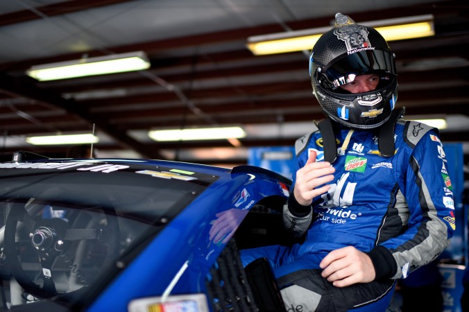 Dale Earnhardt Jr driver of the #88 Nationwide Chevrolet climbs into his car during practice for the NASCAR Sprint Cup Series GEICO 500 at Talladega Superspeedway on April 29