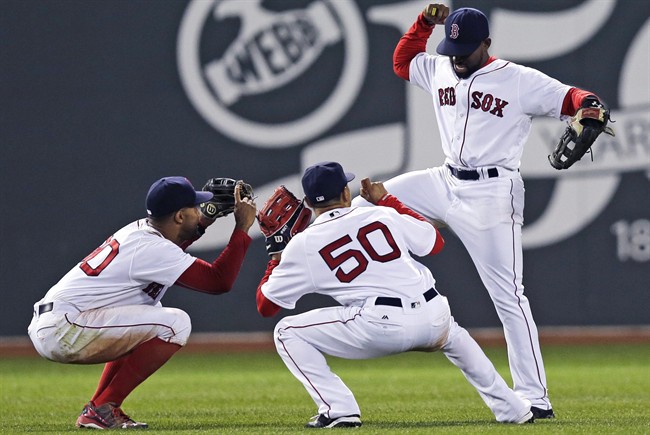 Boston Red Sox center fielder Jackie Bradley Jr. right celebrates with Chris Young and Mookie Betts after the team's baseball game against the Colorado Rockies in Boston Tuesday