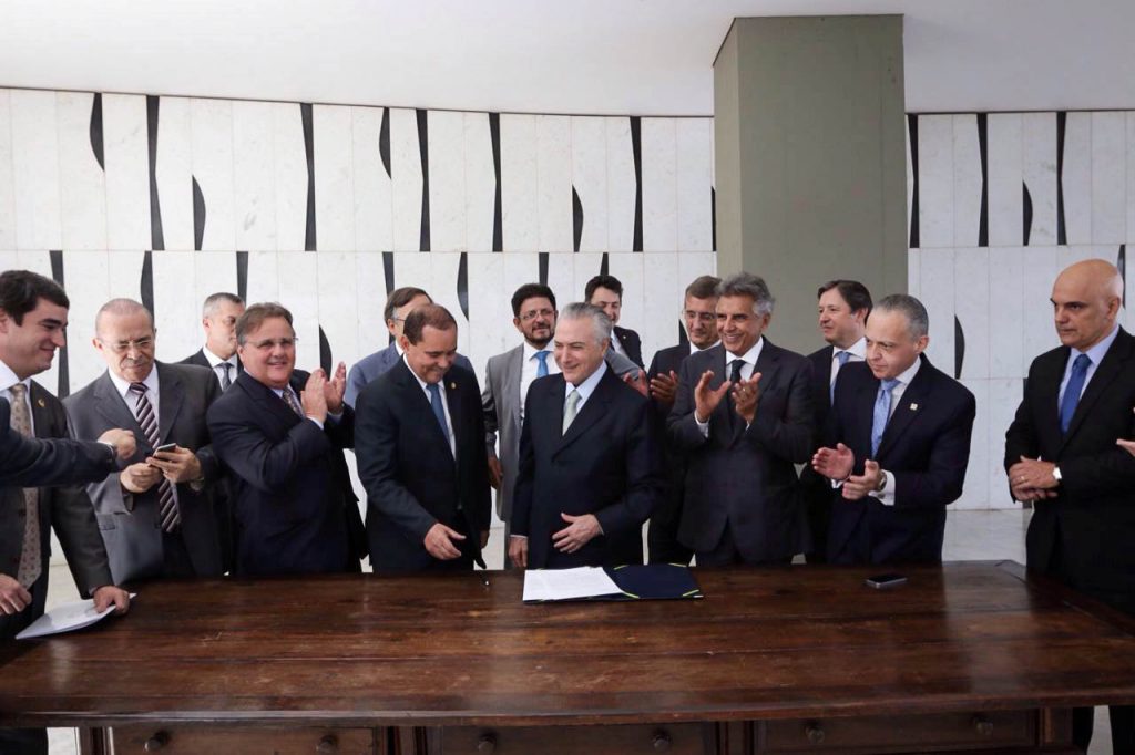 Politicians applaud after Brazil's Vice President Michel Temer signed a document notifying him of becoming the interim president after the Brazilian Senate voted to impeach President Dilma Rousseff. (Marcos Correa  Courtesy of Brazil's Vice Presidency