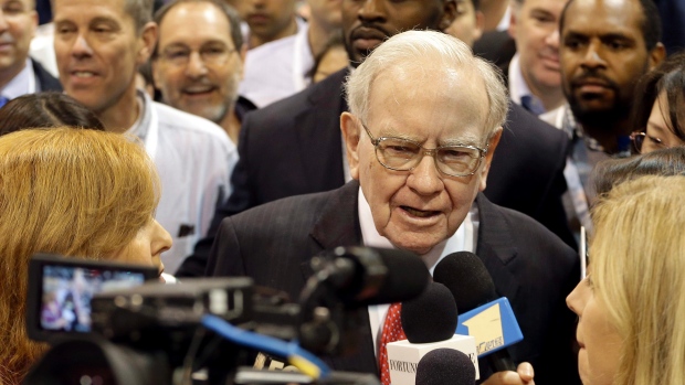 Berkshire Hathaway chairman and CEO Warren Buffett tours the exhibit floor before presiding over the annual shareholders meeting Saturday in Omaha Neb