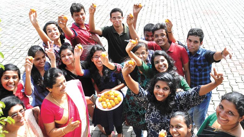 Students celebrate their success at Campion School Edappally with principal Leelamma Thomas and teachers after CBSE announced its 12th class results on Saturday