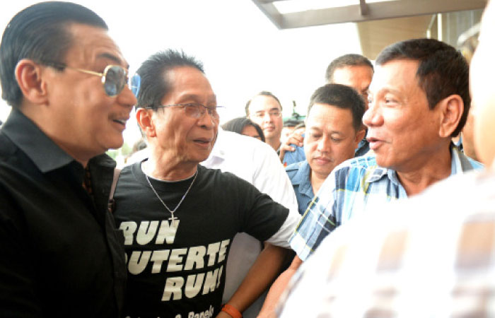 Philippines’ president-elect Rodrigo Duterte right greets movie star turned politician ER Ejercito left after a press conference in Davao City in the southern island of Mindanao on Monday. — AFP