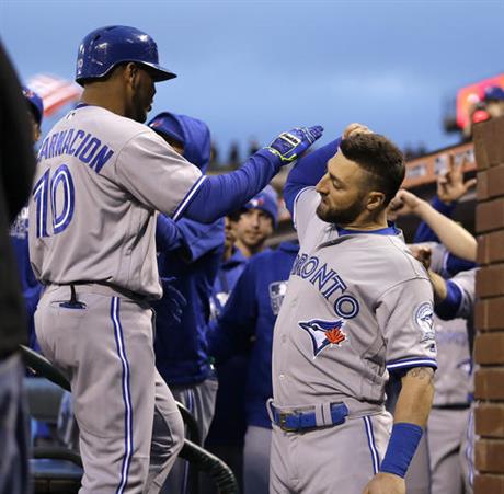 Toronto Blue Jays&#039 Edwin Encarnacion left celebrates with Kevin Pillar after hitting a two-run home run off San Francisco Giants&#039 Jake Peavy in the third inning of a baseball game Monday