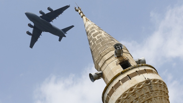 A U.S. Air Force Boeing C-17A Globemaster III large transport aircraft flies over a minaret after taking off from Incirlik air base in Adana Turkey in August. Four drones deployed from the air base were involved in the coalition-led attacks on ISIS