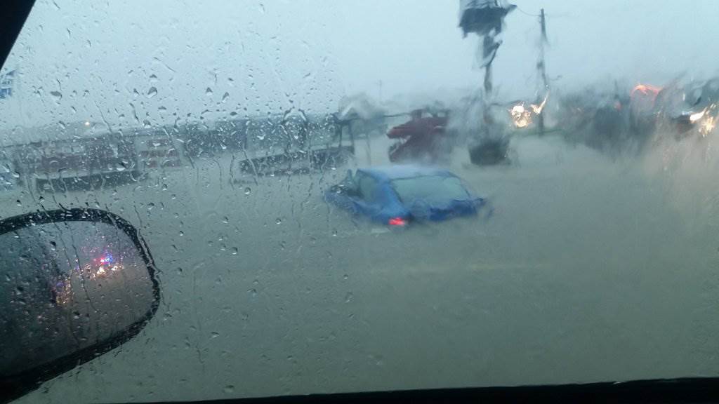 Cars are submerged in floodwaters along Highway 21 in Bryan Texas Thursday