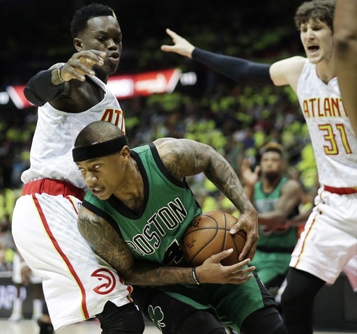 Boston Celtics&#039 Isaiah Thomas center looks to pass against the defense of Atlanta Hawks&#039 Dennis Schroder left of Germany and Mike Muscala right during the first quarter in Game 1 of a first-round NBA basketball playoff series Saturday Ap