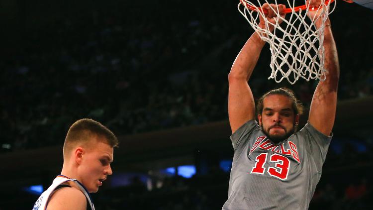 Chicago Bulls center Joakim Noah dunks over New York Knicks forward Kristaps Porzingis