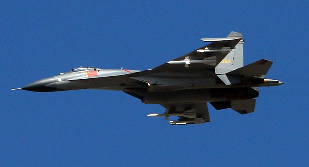 The latest Chinese Jian-series fighter jet executes a fly-by over Beijing