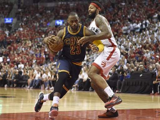 Cleveland Cavaliers forward Le Bron James drives to the basket as Toronto Raptors forward James Johnson defends during the second half of Game 6 of the NBA basketball Eastern Conference finals Friday