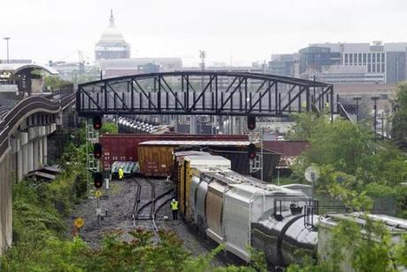 Emergency personnel work at the scene after a CSX freight train derailed in Washington on Sunday