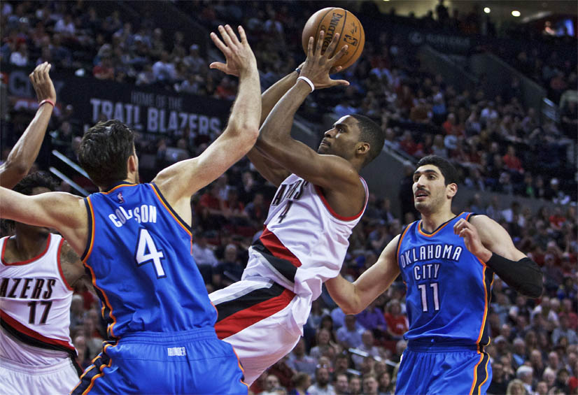 Portland Trail Blazers forward Maurice Harkless center shoots between Oklahoma City Thunder forward Nick Collison left and center Enes Kanter right during the second half of an NBA basketball game in Portland Ore. Wednesday